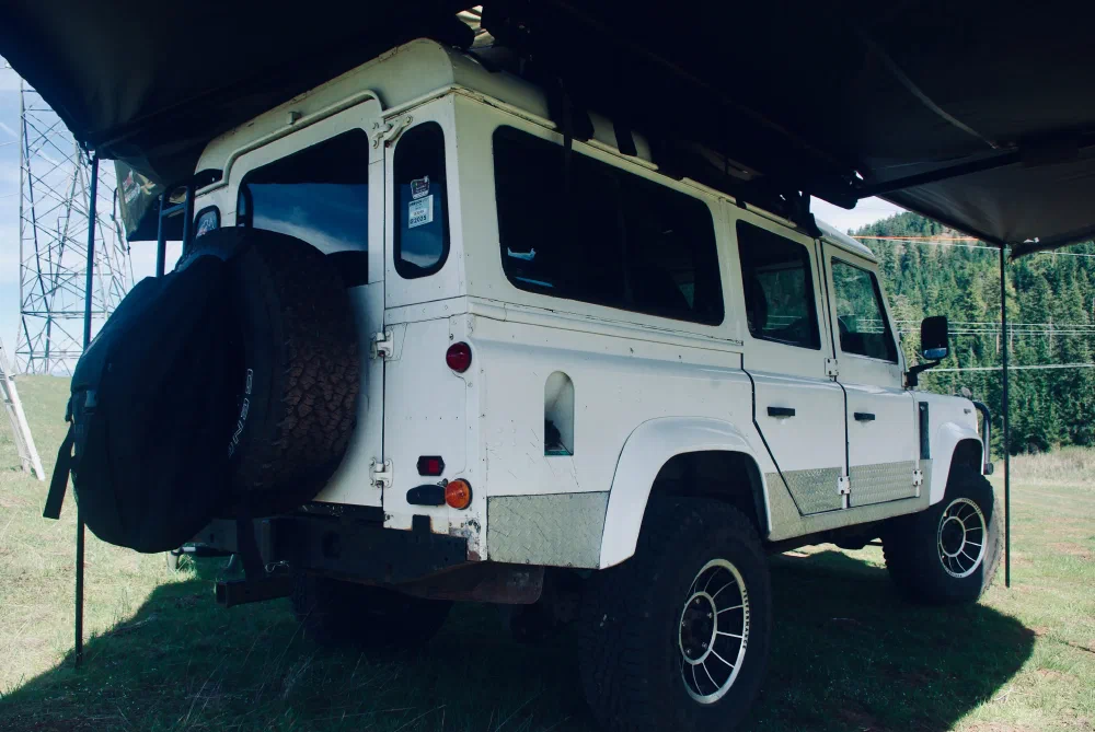 Rear view of the Perentie 110 under its awning with rooftop tent deployed