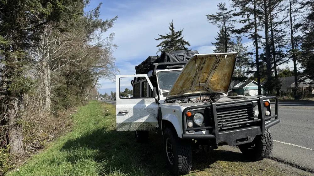 Perentie 110 roadside with hood open on a sunny day
